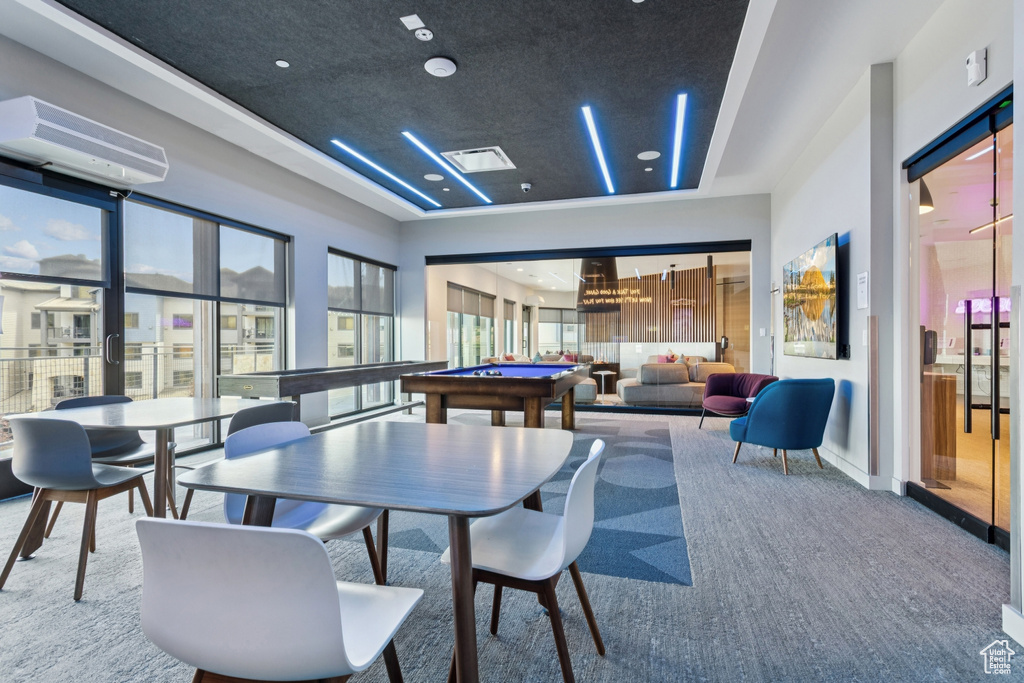 Recreation room featuring billiards table, a tray ceiling, carpet, and an AC wall unit