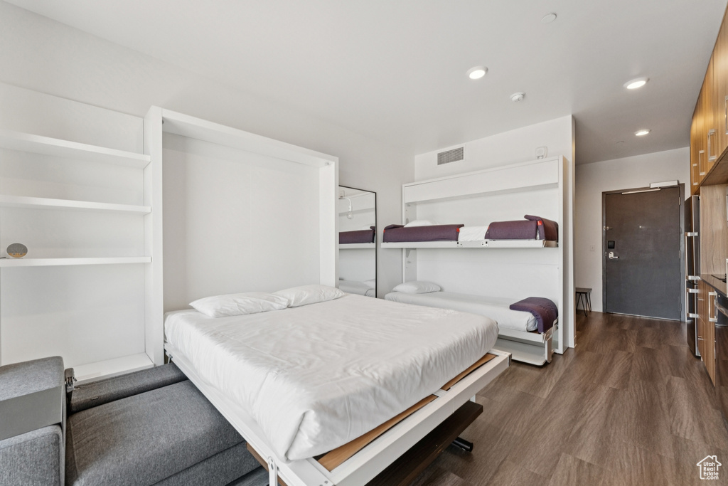 Bedroom featuring dark wood-type flooring and recessed lighting