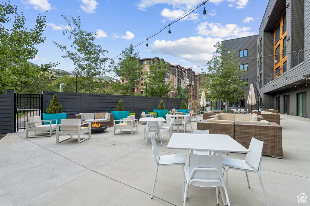 View of patio featuring an outdoor living space with a fire pit