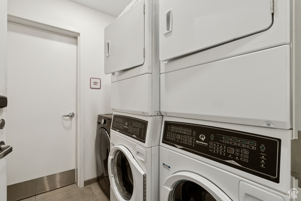 Washroom featuring washing machine and clothes dryer and light tile patterned floors
