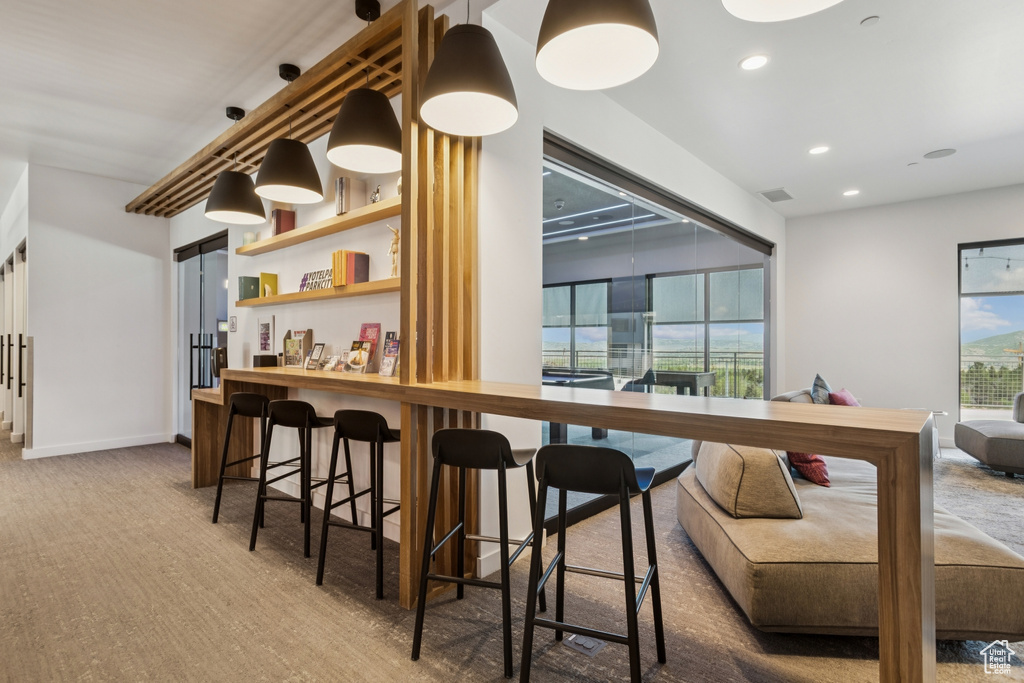 Bar area featuring carpet and recessed lighting
