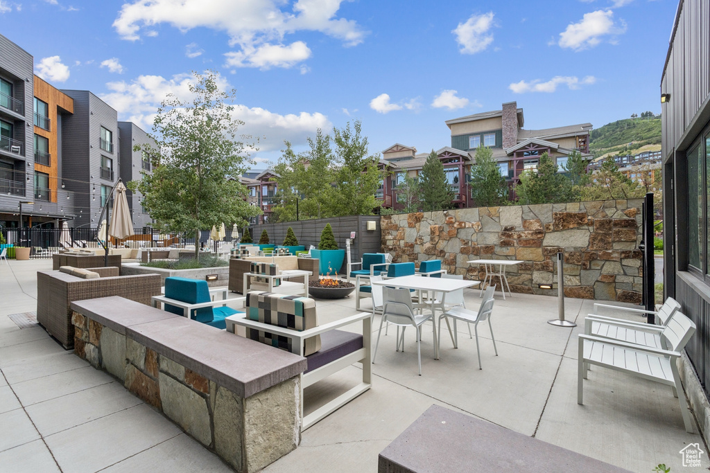 View of patio featuring a residential view and an outdoor living space with a fire pit