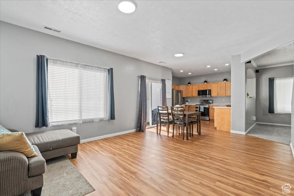Living area featuring light wood-style flooring and recessed lighting