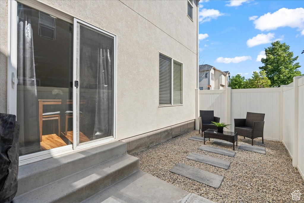 Fenced backyard with entry steps and a patio area