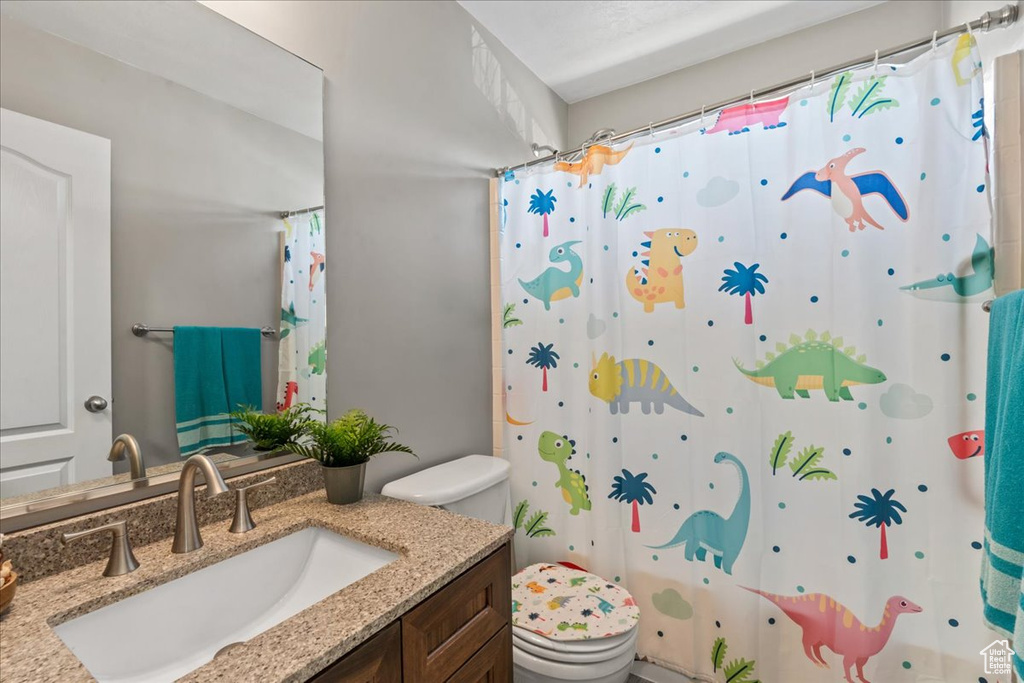 Full bathroom featuring vanity and curtained shower