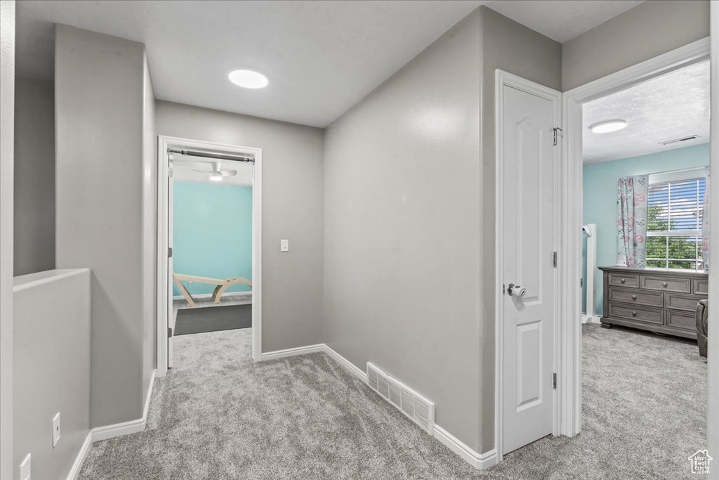 Hall featuring carpet and baseboards