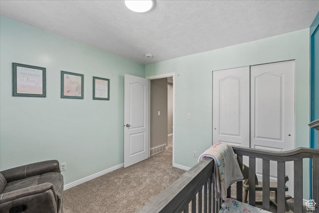 Bedroom with carpet and a closet