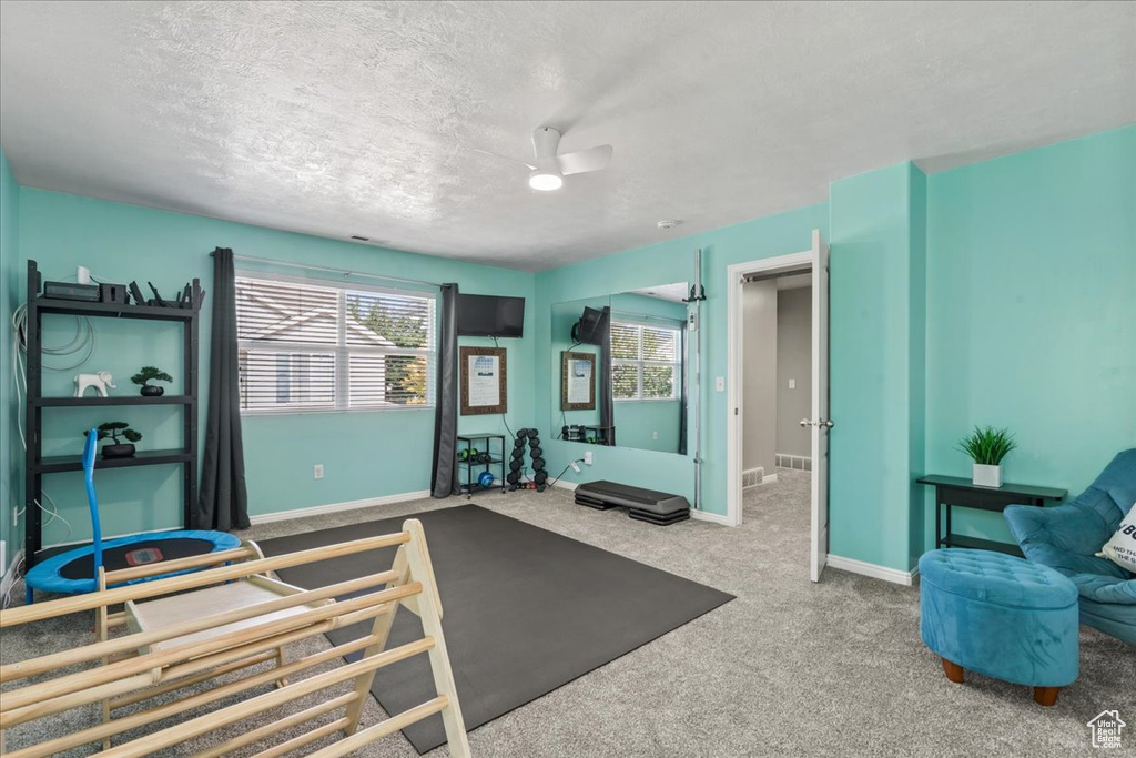 Bedroom featuring a textured ceiling and carpet floors