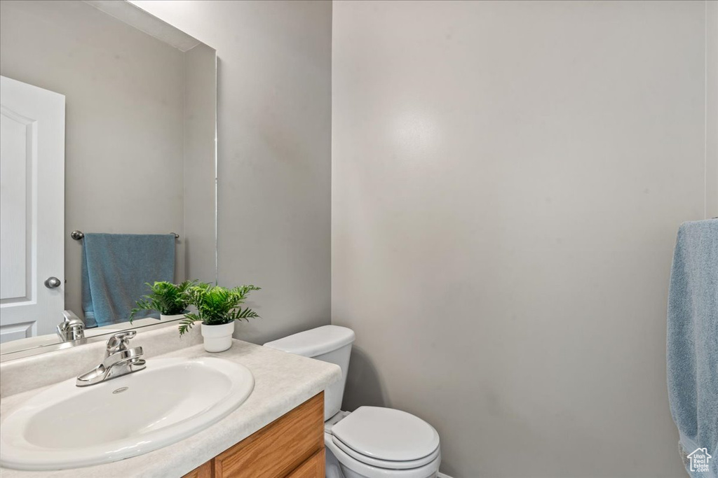 Half bathroom with toilet and vanity