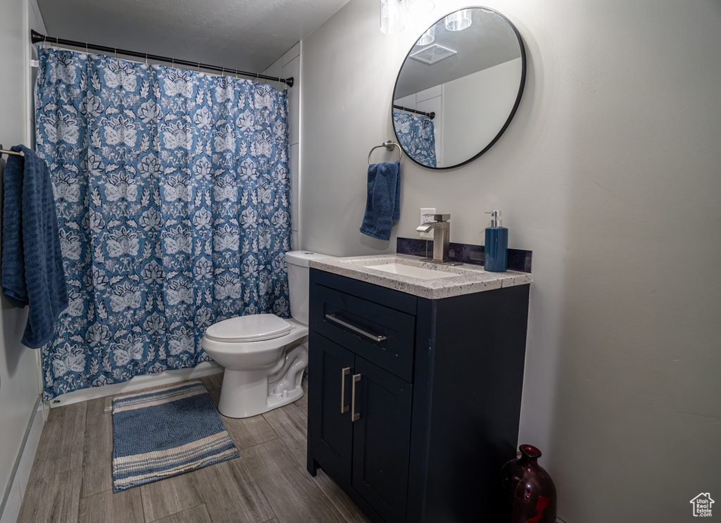 Bathroom with vanity and wood finished floors