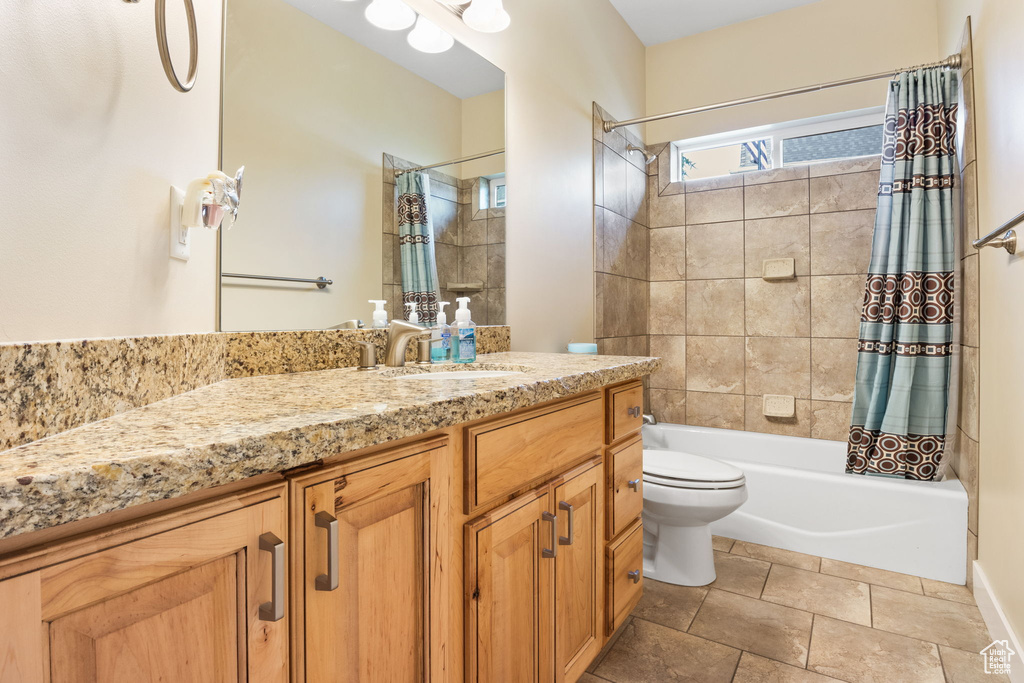 Bathroom featuring vanity and shower / bath combination with curtain