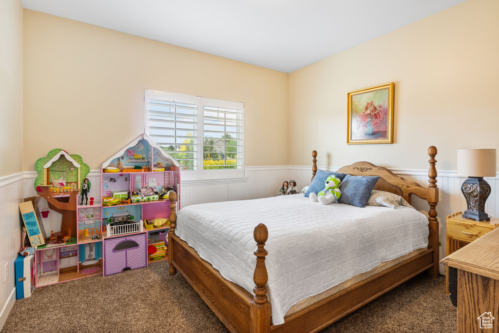 Bedroom with carpet floors and wainscoting