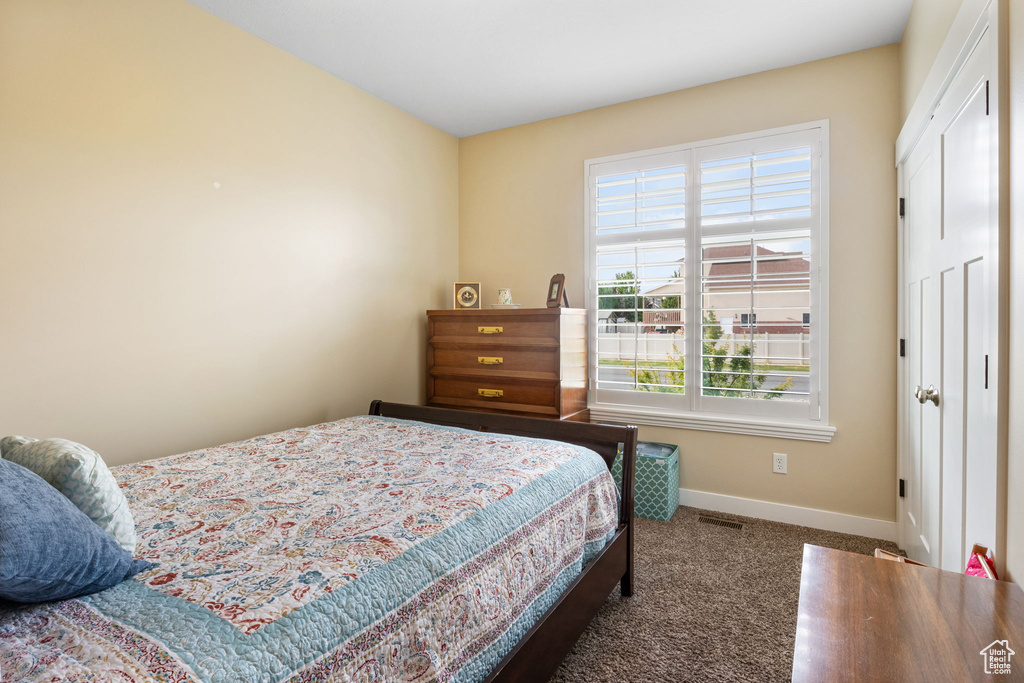 Carpeted bedroom featuring baseboards