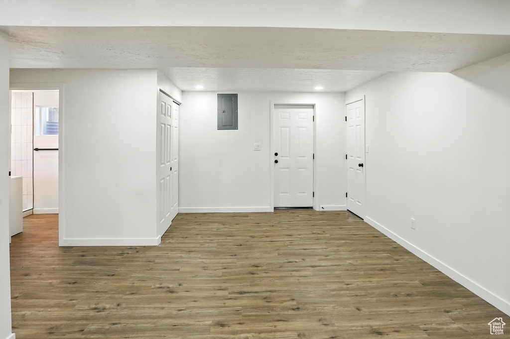 Foyer featuring electric panel, wood finished floors, recessed lighting, and a textured ceiling