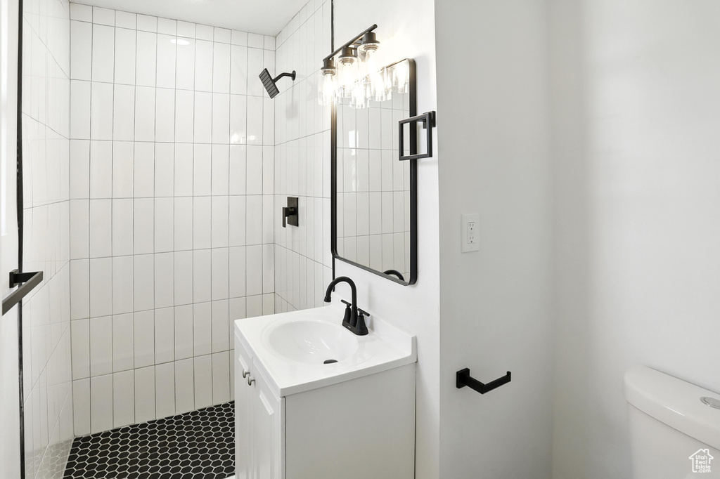 Bathroom featuring vanity and a tile shower