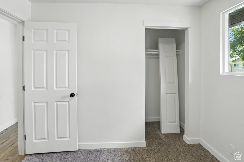 Unfurnished bedroom featuring baseboards and a closet