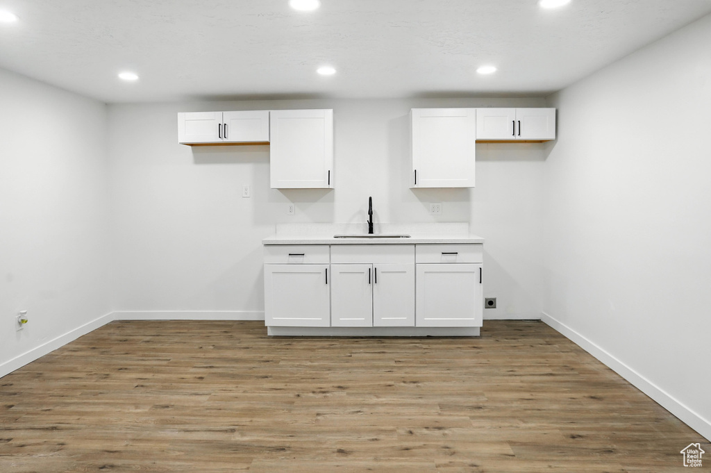 Kitchen with white cabinetry, recessed lighting, light wood-style floors, and light countertops