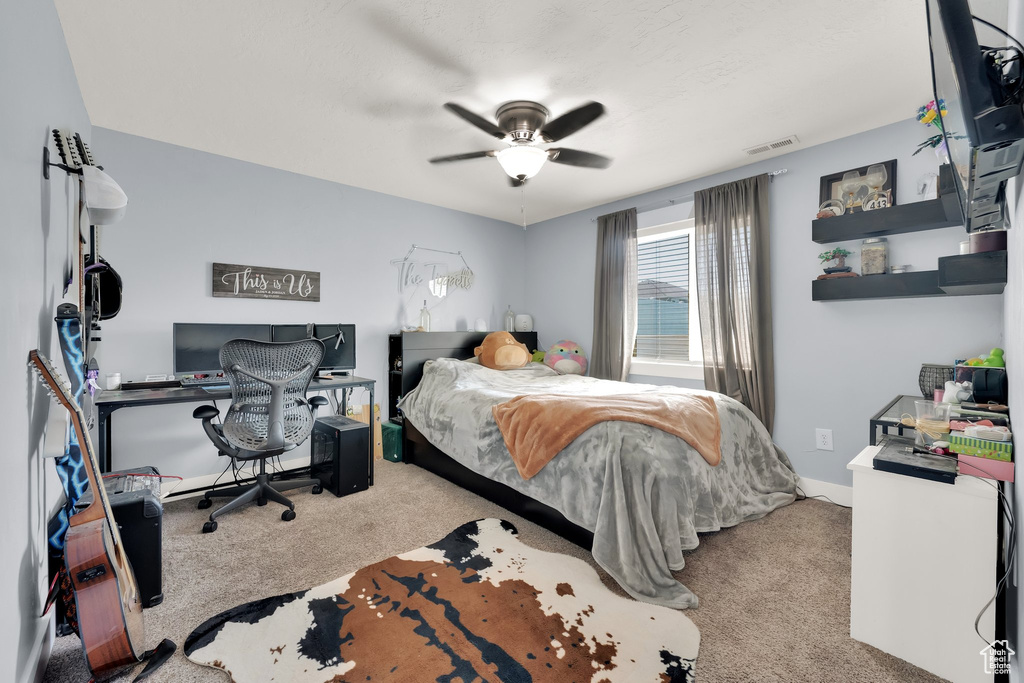Bedroom featuring carpet, ceiling fan, and an office area