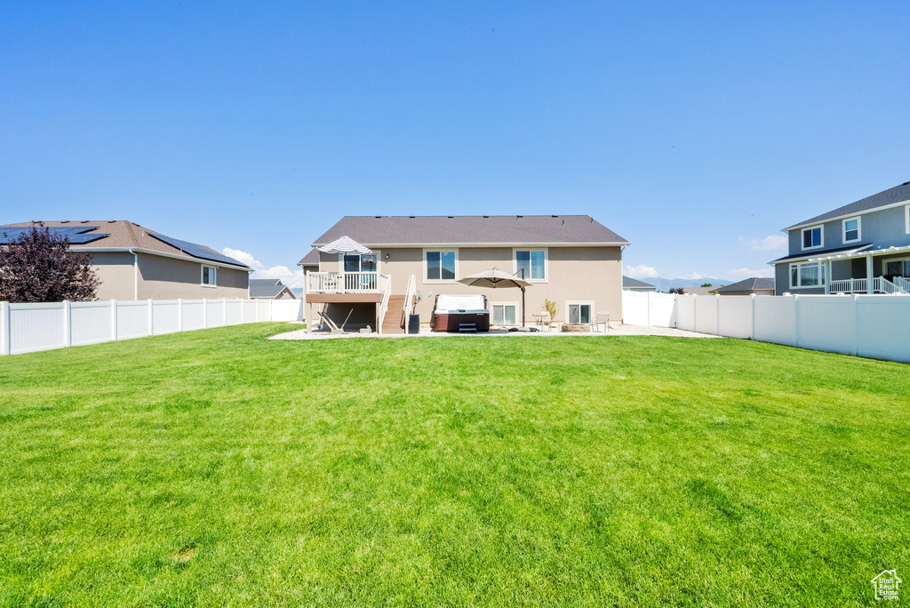 Rear view of property featuring a patio area, a fenced backyard, and stucco siding