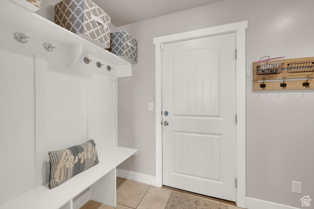 Mudroom with light tile patterned flooring and baseboards