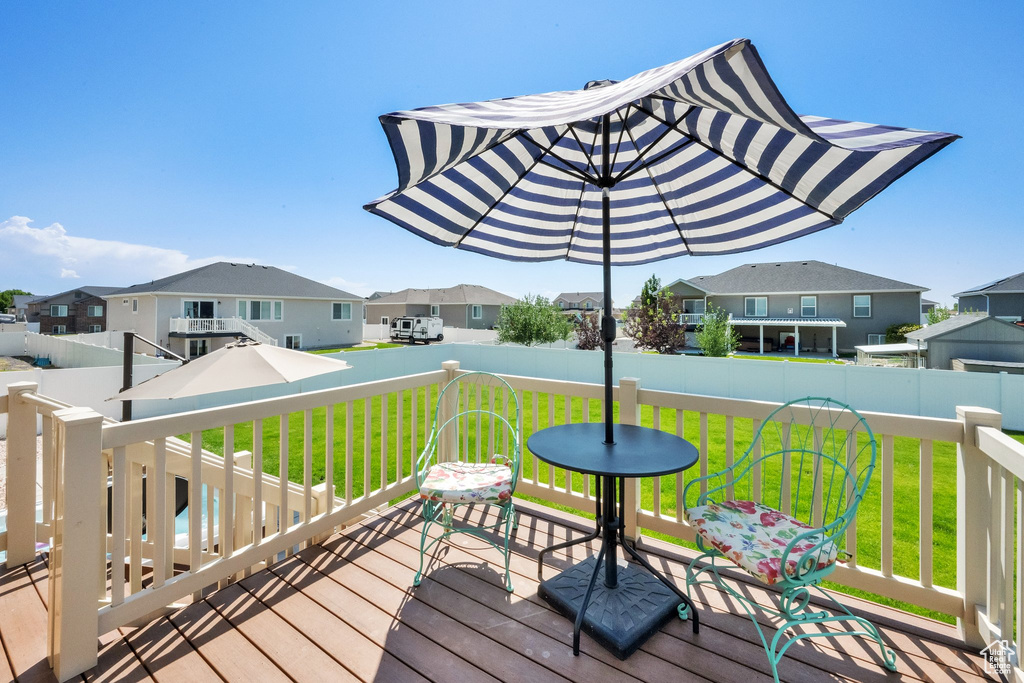 Deck with a residential view and a lawn