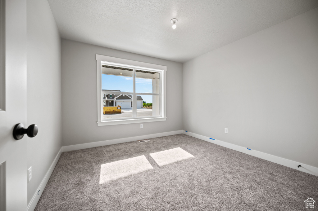 Spare room with carpet floors and baseboards