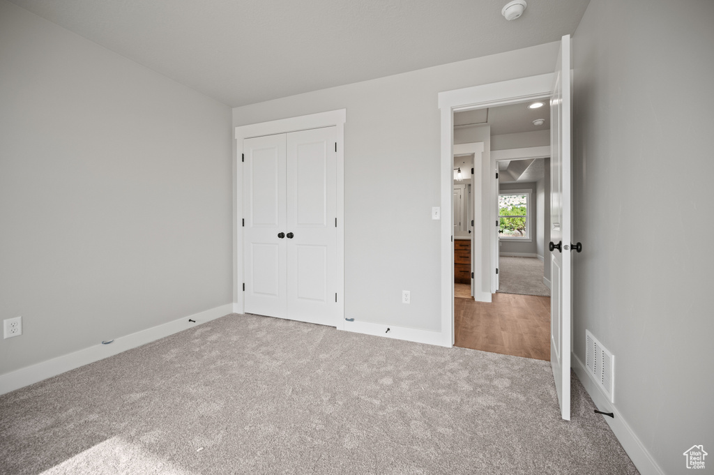Unfurnished bedroom with carpet floors and a closet