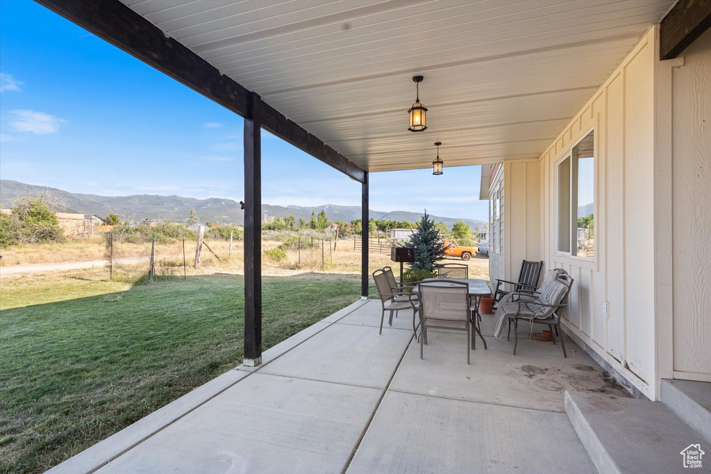View of patio / terrace with a mountain view and outdoor dining area
