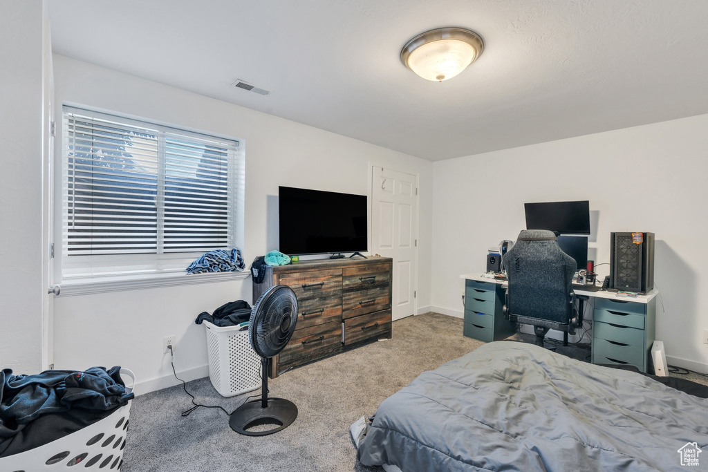 Bedroom with light carpet and baseboards