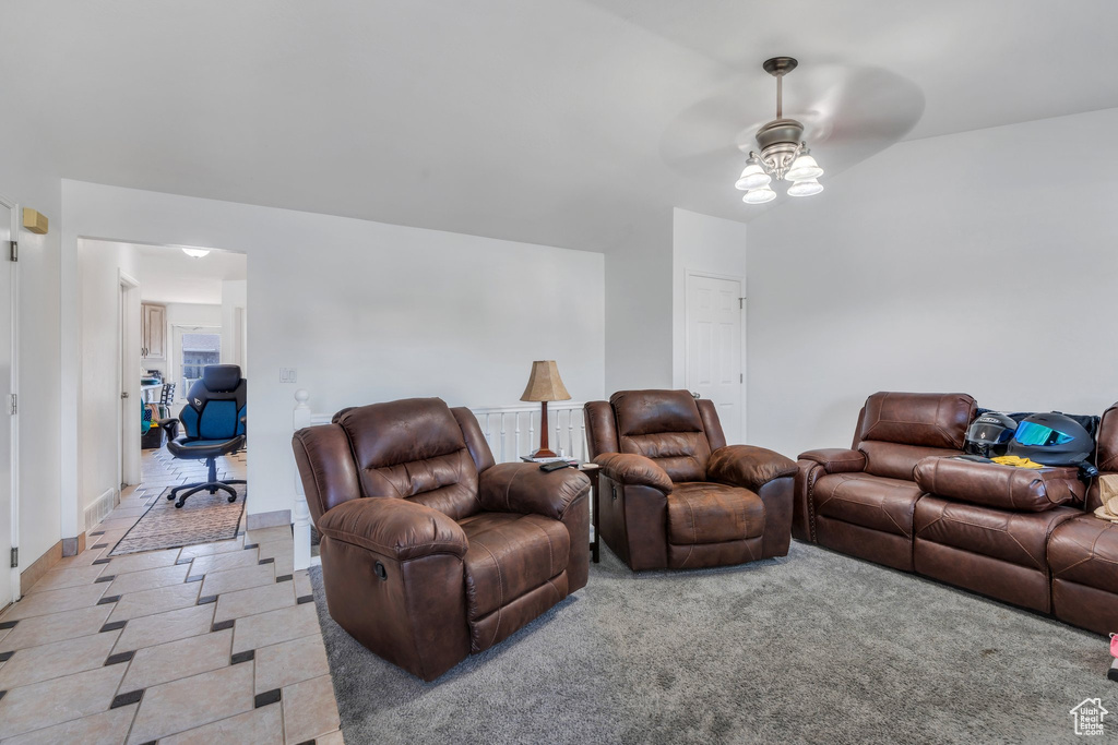 Living room with ceiling fan and a desk