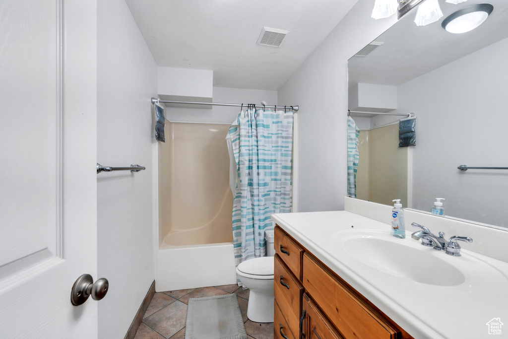 Full bathroom featuring vanity and shower / bath combination with curtain
