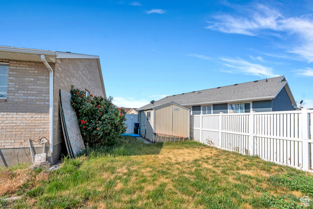 Fenced backyard with a storage unit
