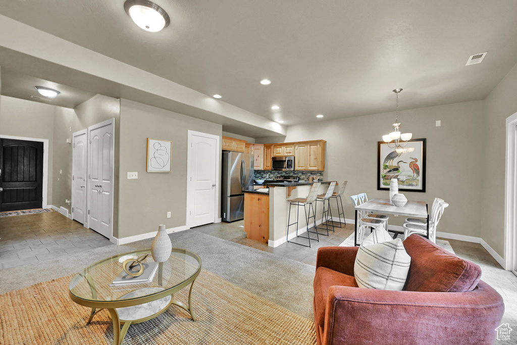 Living area with a chandelier and recessed lighting