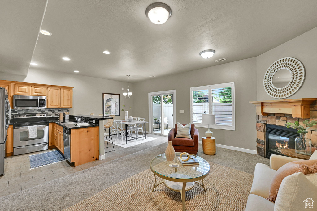 Living room featuring recessed lighting and a stone fireplace