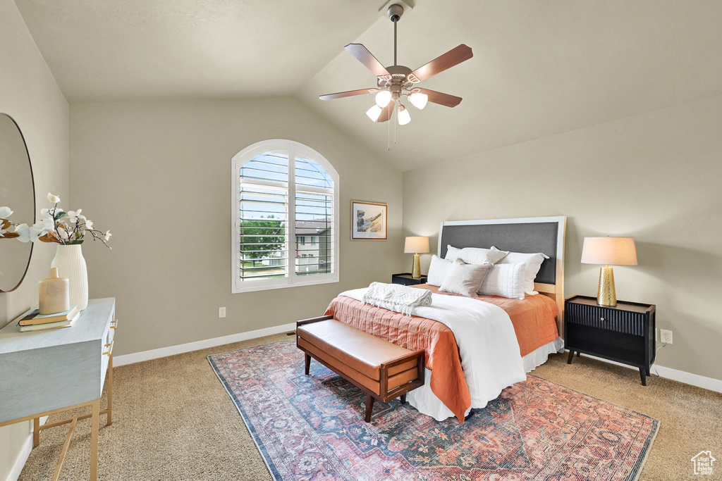 Bedroom featuring carpet, lofted ceiling, and a ceiling fan