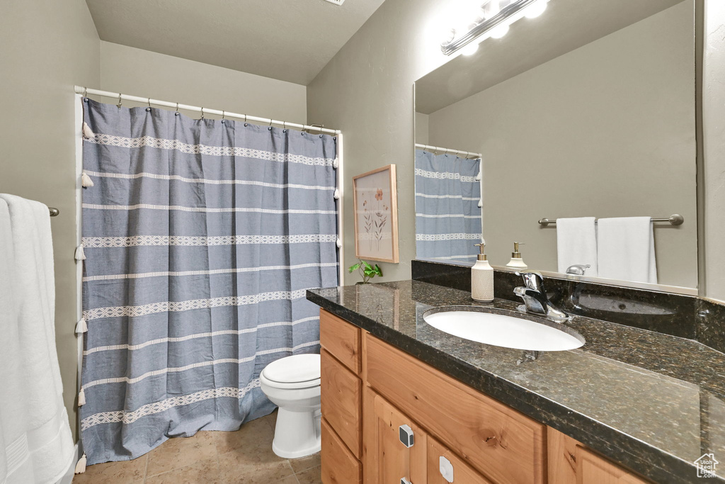 Bathroom featuring vanity, a shower with curtain, and tile patterned floors