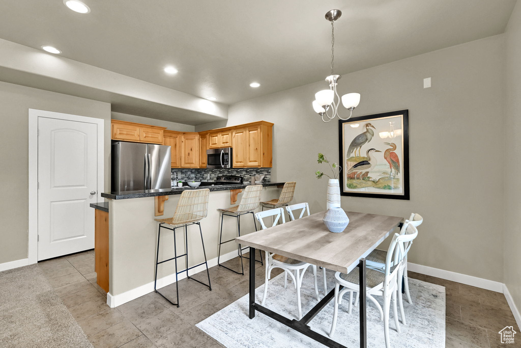 Dining room featuring a chandelier and recessed lighting