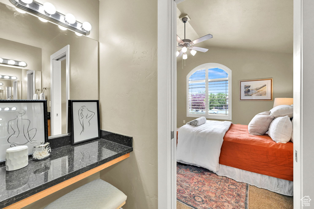 Bedroom with carpet floors, vaulted ceiling, and ceiling fan