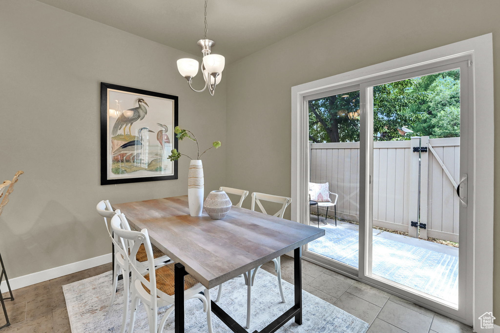 Dining area with baseboards and a chandelier