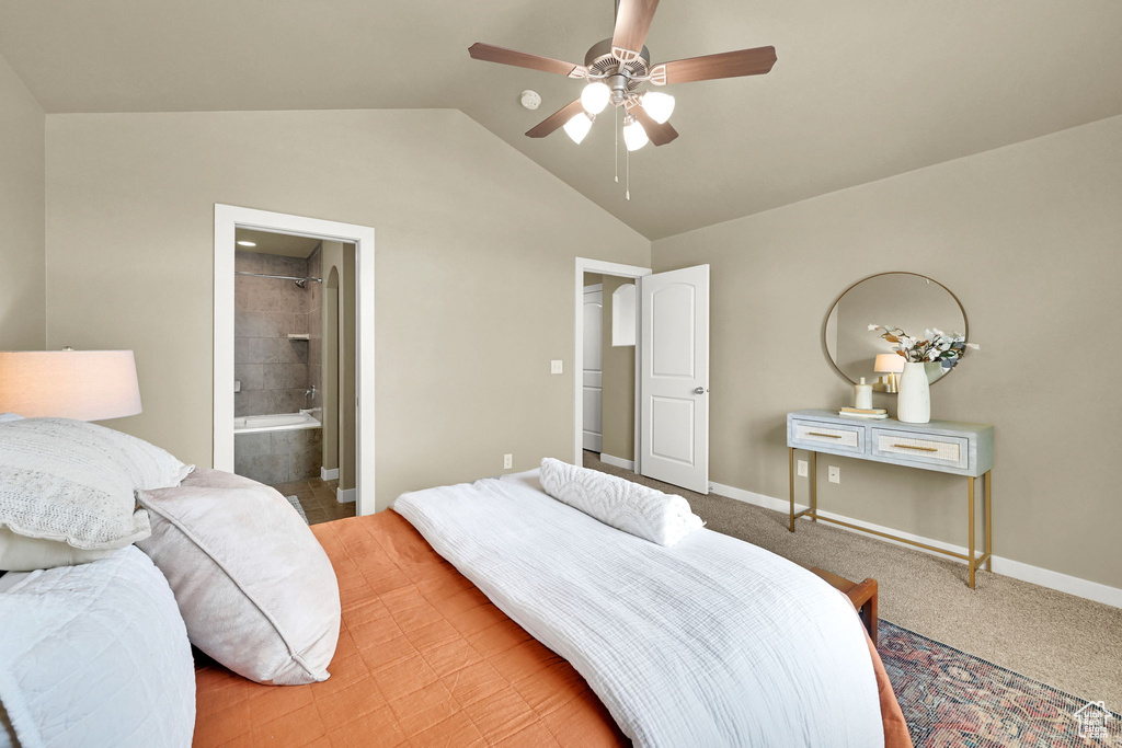 Bedroom featuring vaulted ceiling, ceiling fan, connected bathroom, and light colored carpet