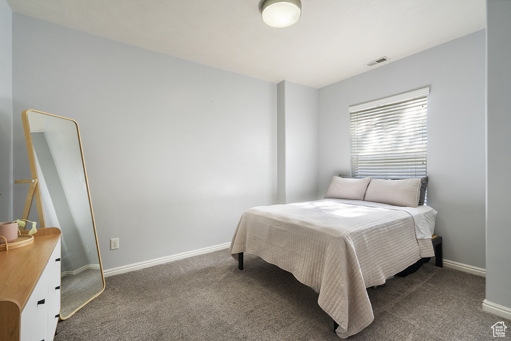 Carpeted bedroom with baseboards