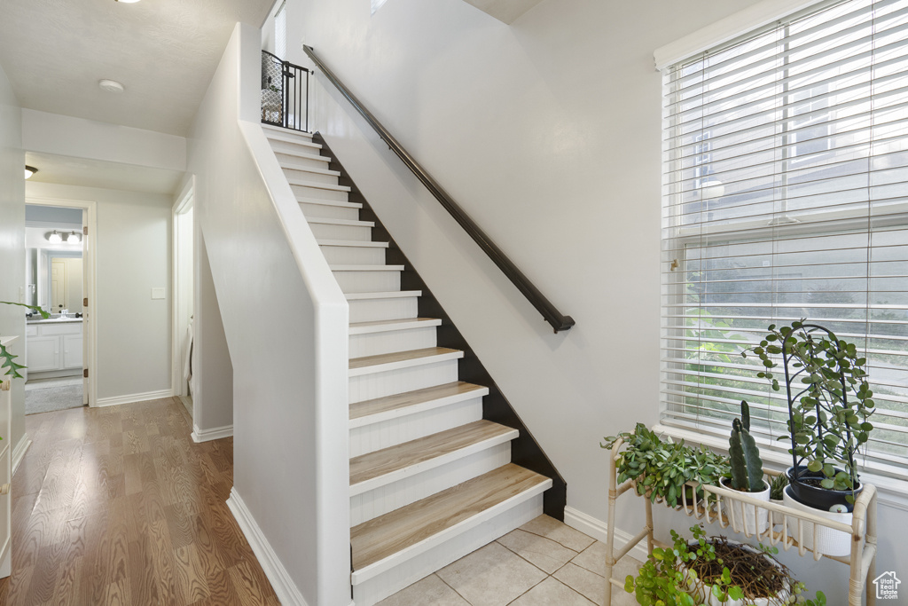 Stairs featuring baseboards and wood finished floors