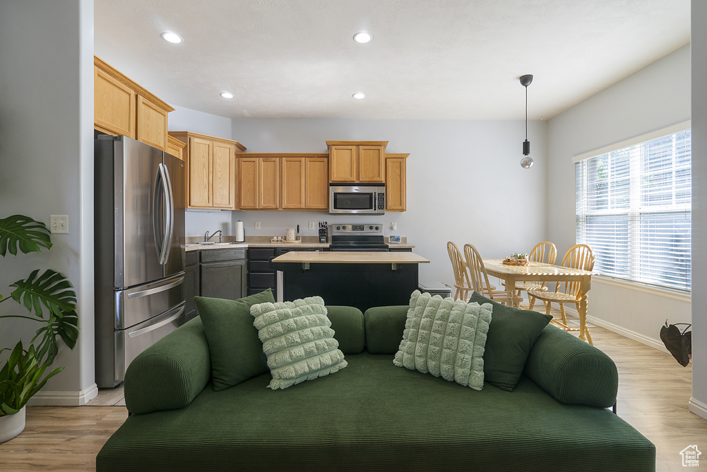 Living area featuring recessed lighting and light wood-style flooring