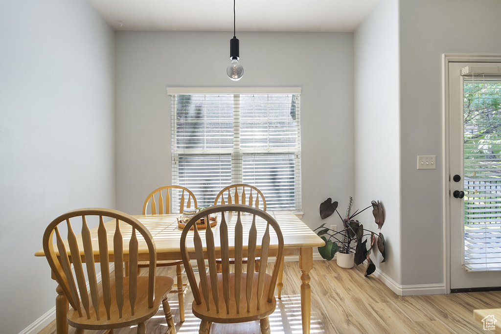Dining space with baseboards and light wood-style floors