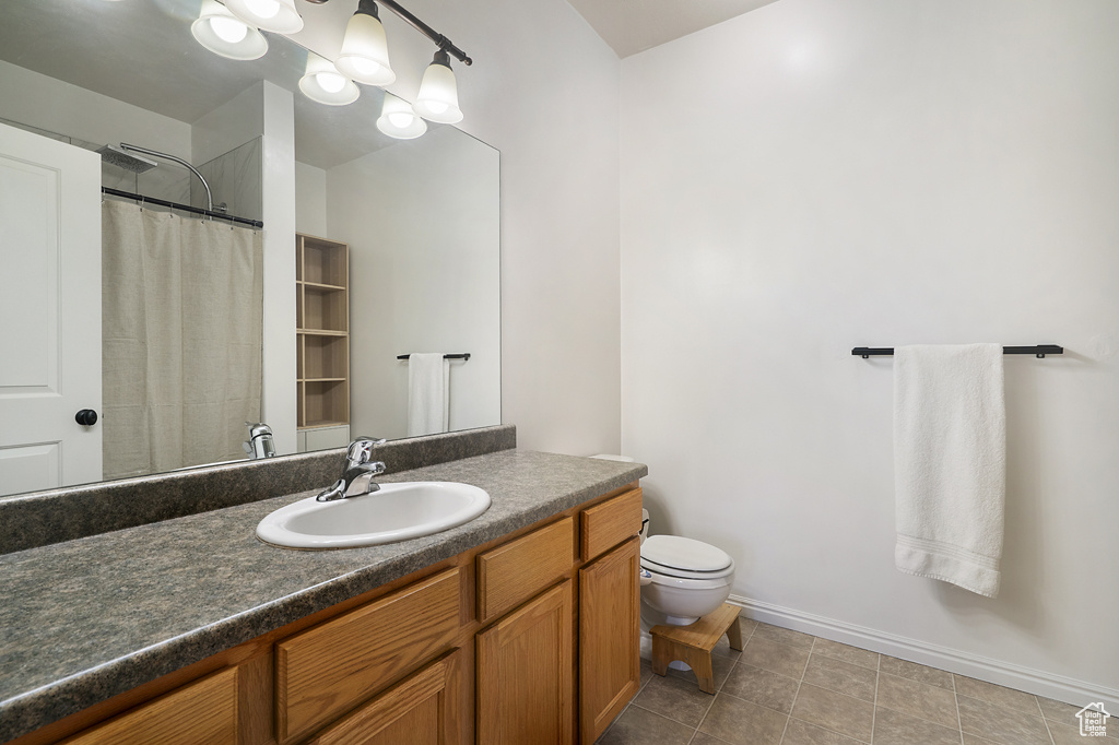 Bathroom featuring vanity, tile patterned flooring, and a shower with curtain