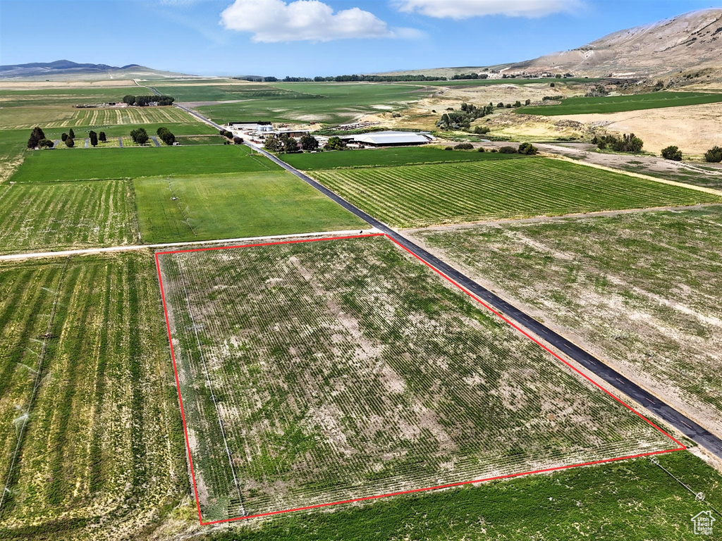 Aerial view of sparsely populated area featuring extensive farmland and property parcel outlined