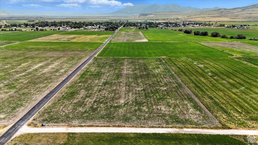 View of rural area featuring large plots for crops and a mountain backdrop