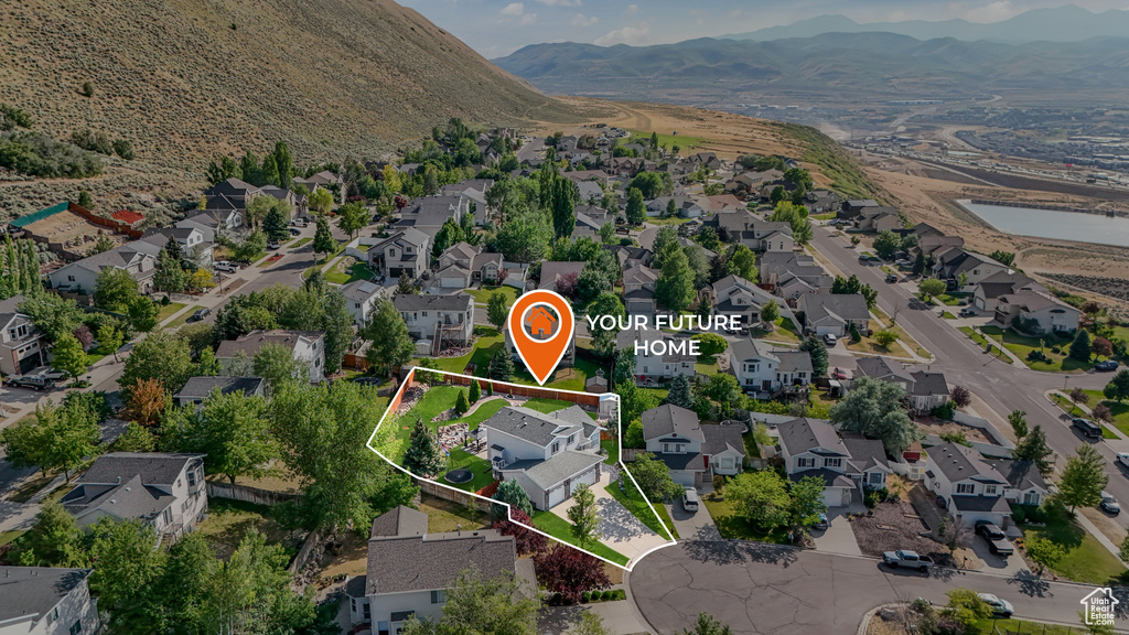 View of property location featuring nearby suburban area, property boundaries highlighted, and a mountainous background