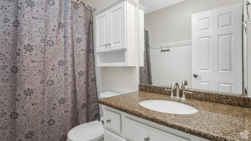 Full bathroom with vanity and a shower with shower curtain