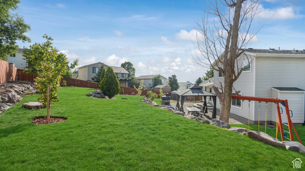 Fenced backyard with a gazebo and a residential view